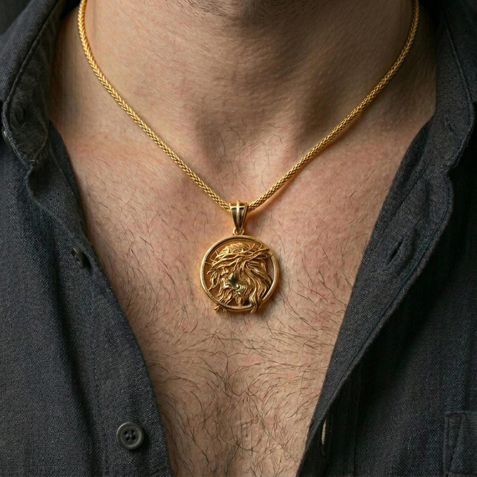 Gold plated Jesus Christ pendant with crown of thorns and flowing profile detail worn on the neck in a premium lifestyle composition with timeless Christian jewelry styling