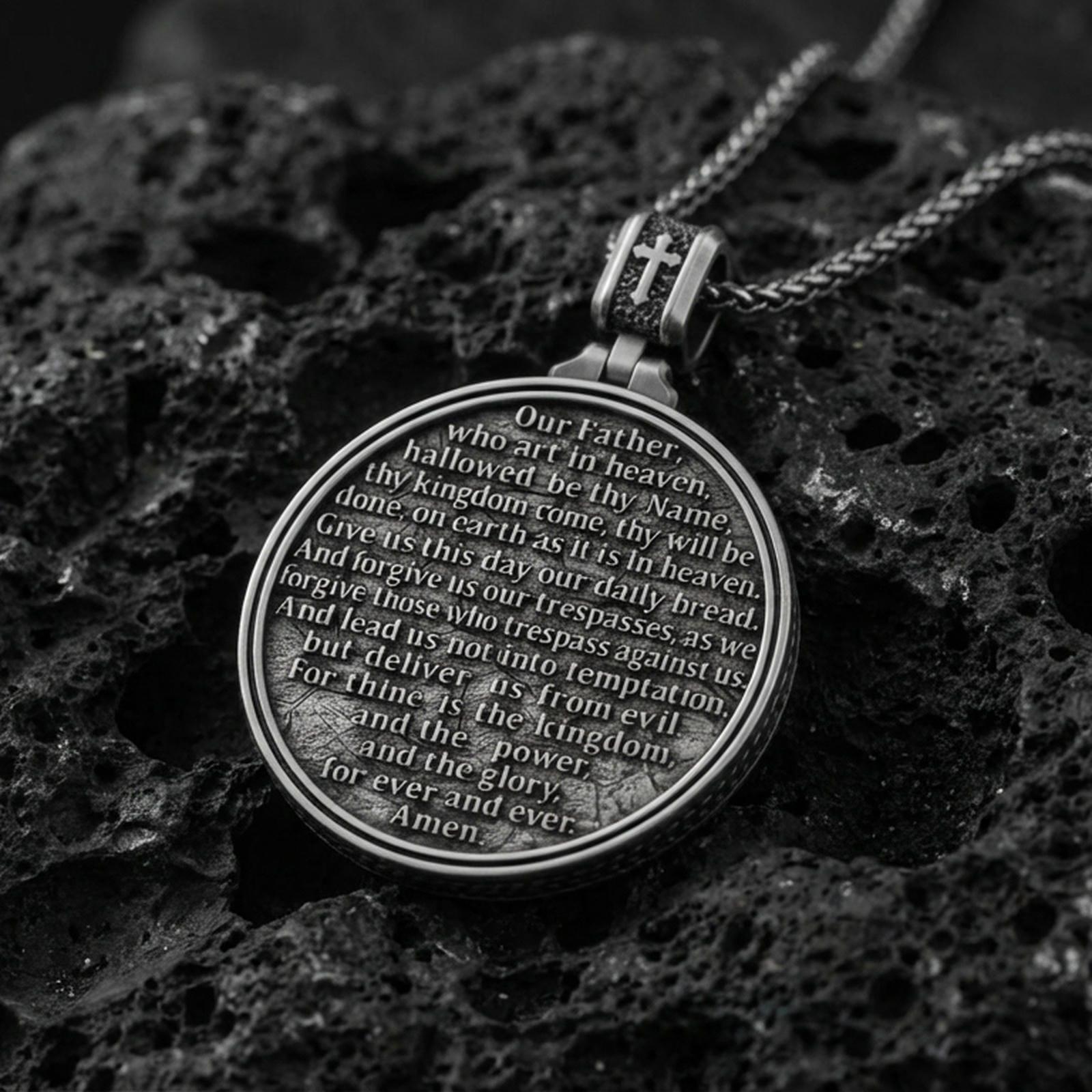 Oxidized Last Supper pendant with Pray for Us inscription, detailed round medallion design, and two-sided devotional concept displayed on dark volcanic rock in a close-up luxury jewelry composition