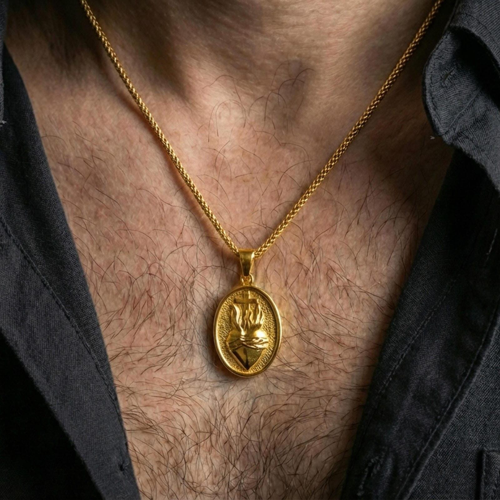 Gold plated Sacred Heart necklace with cross and flame motif worn on the neck in a premium lifestyle composition with timeless Christian jewelry styling