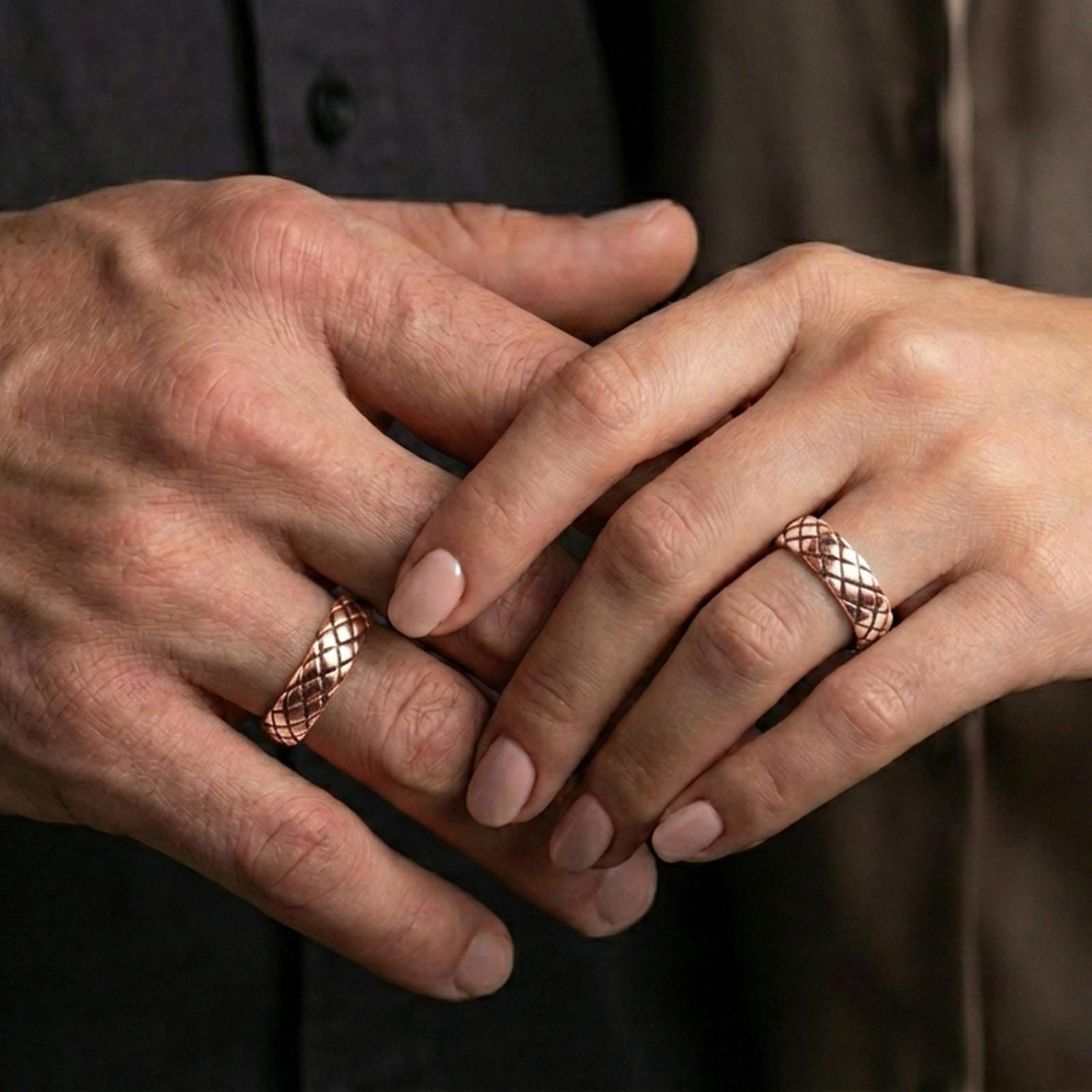Rose gold plated woven texture band ring worn on a finger, lifestyle photo featuring elegant rosy sheen and detailed woven texture.