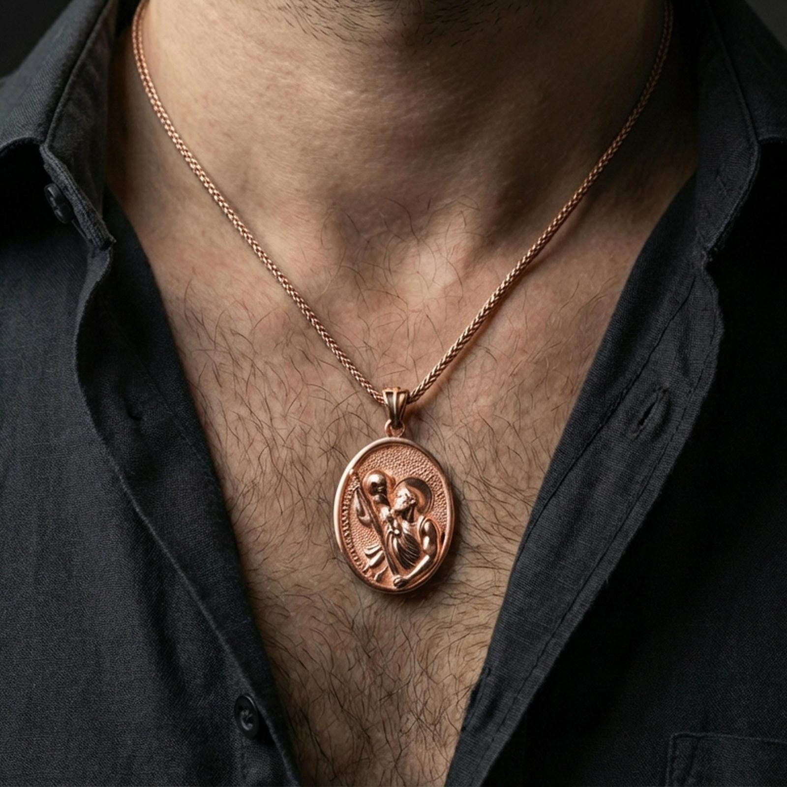 Rose gold plated Saint Christopher pendant with Child Jesus and staff detail worn on the neck in a refined lifestyle shot with a warm and elegant presentation