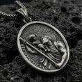 Load image into Gallery viewer, Oxidized Saint Christopher pendant with Child Jesus, staff detail, and oval devotional portrait displayed on dark volcanic rock in a close-up luxury jewelry composition
