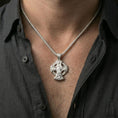 Load image into Gallery viewer, Polished silver Archangel Michael pendant with ornate cross silhouette worn on the neck in a close lifestyle frame, highlighting the detailed heavenly relief and sacred symbolism
