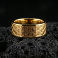 Load image into Gallery viewer, Gold plated geometric floral band ring on volcanic stone, premium close-up showing warm gold tone across the engraved Japanese-inspired pattern.

