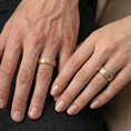 Load image into Gallery viewer, Rose gold plated scrollwork band ring worn on a finger, lifestyle wear photo featuring elegant rose tone and intricate ornamental swirlwork.

