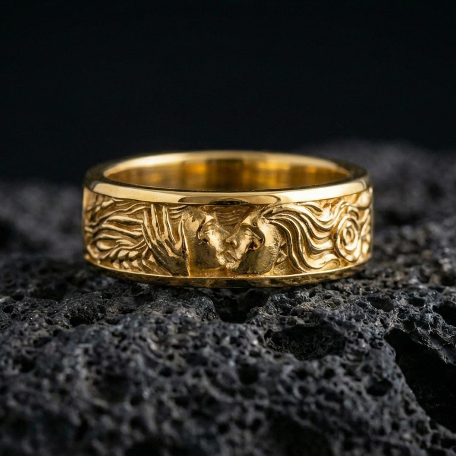 Gold plated lovers face ring on volcanic stone, premium macro shot showing warm gold tone across the romantic portrait and engraved scrollwork sides.