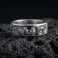 Load image into Gallery viewer, Oxidized sterling silver lovers face ring on volcanic stone, macro close-up highlighting the sculpted couple portrait and dark antique contrast.
