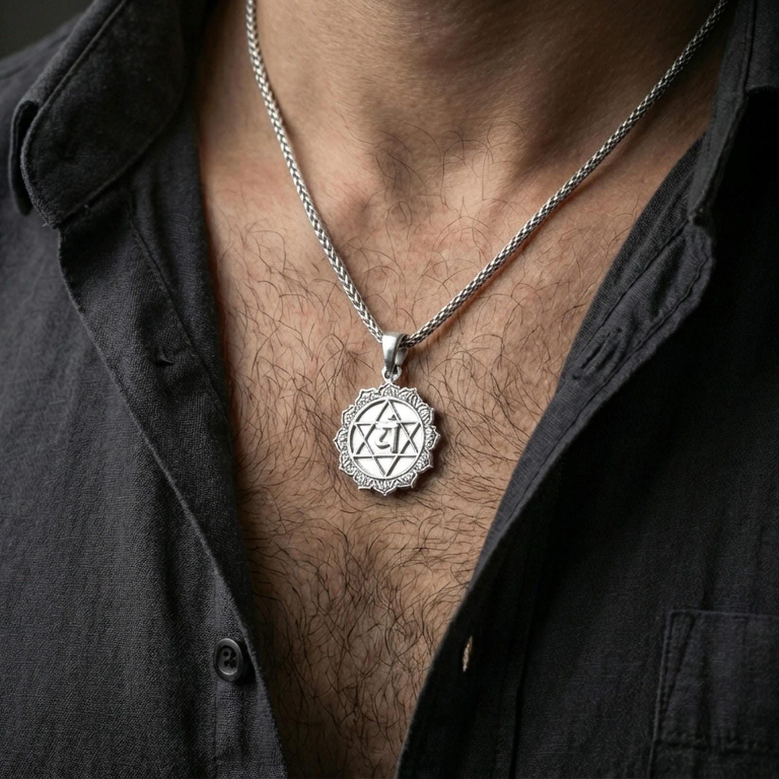 Polished silver heart chakra necklace with geometric star motif worn on the neck in a close lifestyle frame, highlighting the symbolic center and ornate circular design