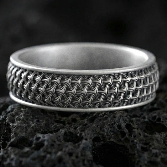 Oxidized sterling silver geometric weave band ring on volcanic stone, macro close-up emphasizing the interlocking lattice texture and dark antique contrast.

Polished silver geometric weave band ring on volcanic stone, crisp product photo highlighting the clean shine and repeating woven pattern detail.
