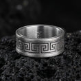 Load image into Gallery viewer, Oxidized sterling silver Greek key spinner ring on volcanic stone, macro close-up highlighting darkened recesses, crisp meander lines, and antique depth.
