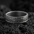 Load image into Gallery viewer, Oxidized sterling silver hammered texture band ring on volcanic stone, macro close-up showcasing deepened recesses, rugged facets, and antique character.
