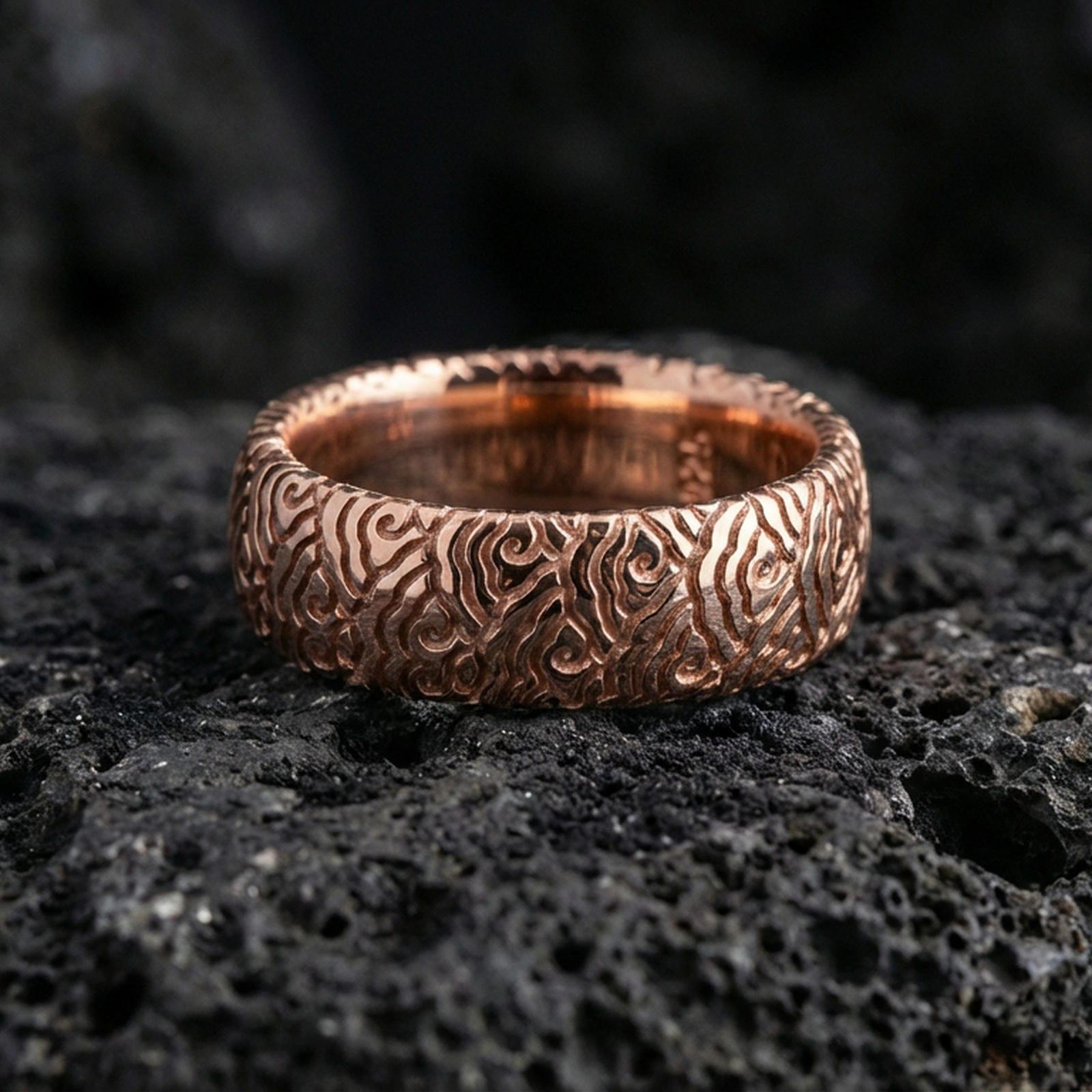 Rose gold plated wave pattern band ring on volcanic stone, elegant macro close-up capturing soft rose reflections over the wave motif and rounded silhouette.