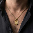 Load image into Gallery viewer, Gold plated Saint Anastasia necklace with framed saint icon and cross detail worn on the neck in a premium lifestyle composition with classic Christian jewelry styling
