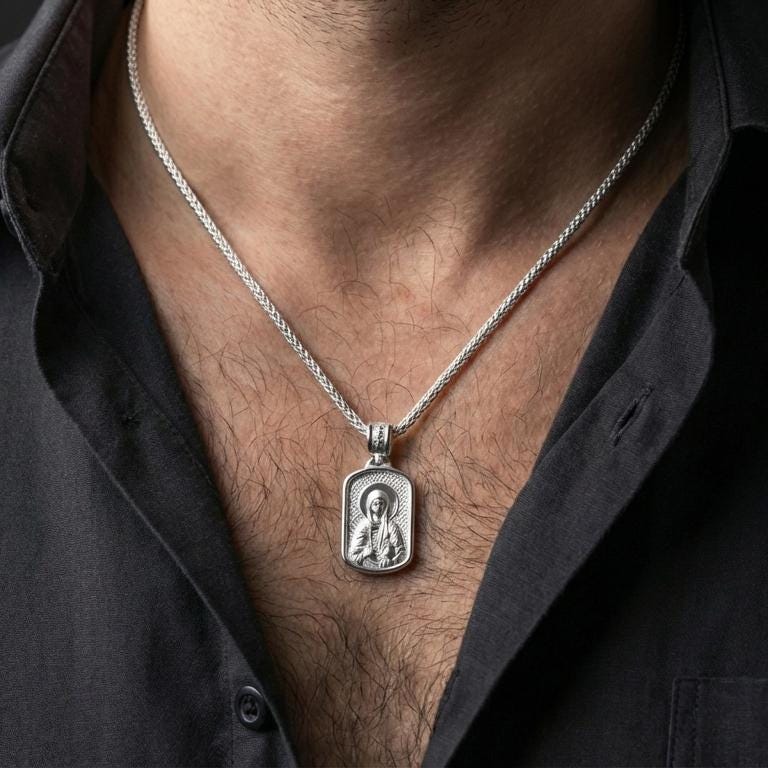 Polished silver Saint Anastasia medallion with orthodox icon relief worn on the neck in a close lifestyle frame, highlighting the saint portrait and detailed sacred background