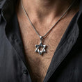 Load image into Gallery viewer, Polished silver Star of David necklace worn on the neck in a close lifestyle frame, highlighting the interlocking hexagram design and refined symbolic silhouette
