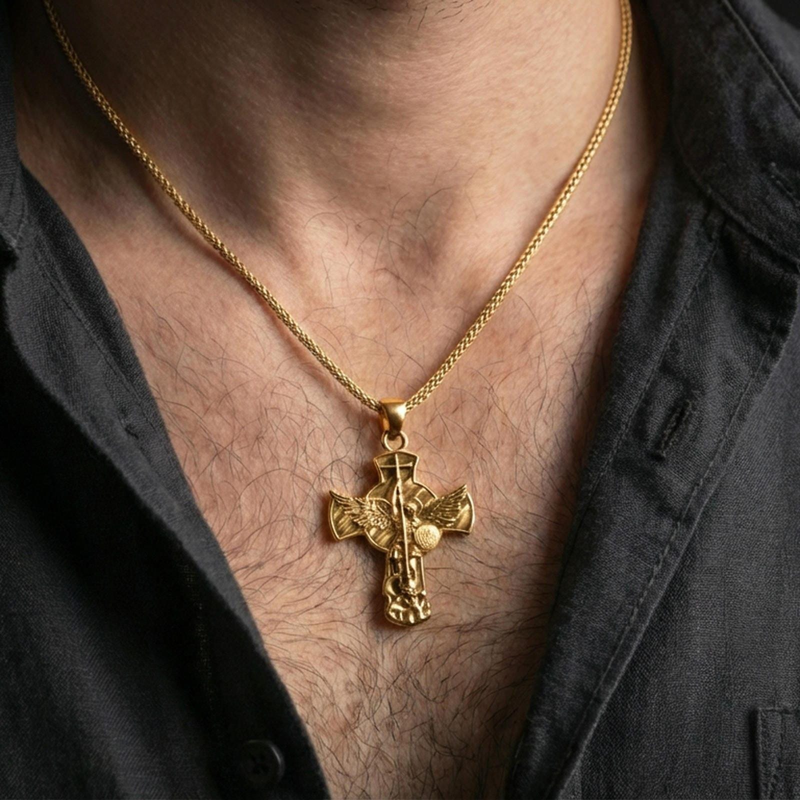 Gold plated Saint Michael necklace with angel warrior motif and Quis Ut Deus detail worn on the neck in a premium lifestyle composition with strong Christian jewelry styling