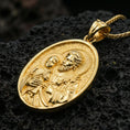 Load image into Gallery viewer, Gold plated Saint Joseph pendant with Child Jesus figure, floral detail, and classic Catholic oval medal design showcased on black volcanic rock in a refined macro jewelry image
