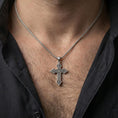 Load image into Gallery viewer, Oxidized Celtic cross pendant with intricate knotwork worn on the neck in a lifestyle jewelry shot, styled against the chest for a bold and meaningful look

