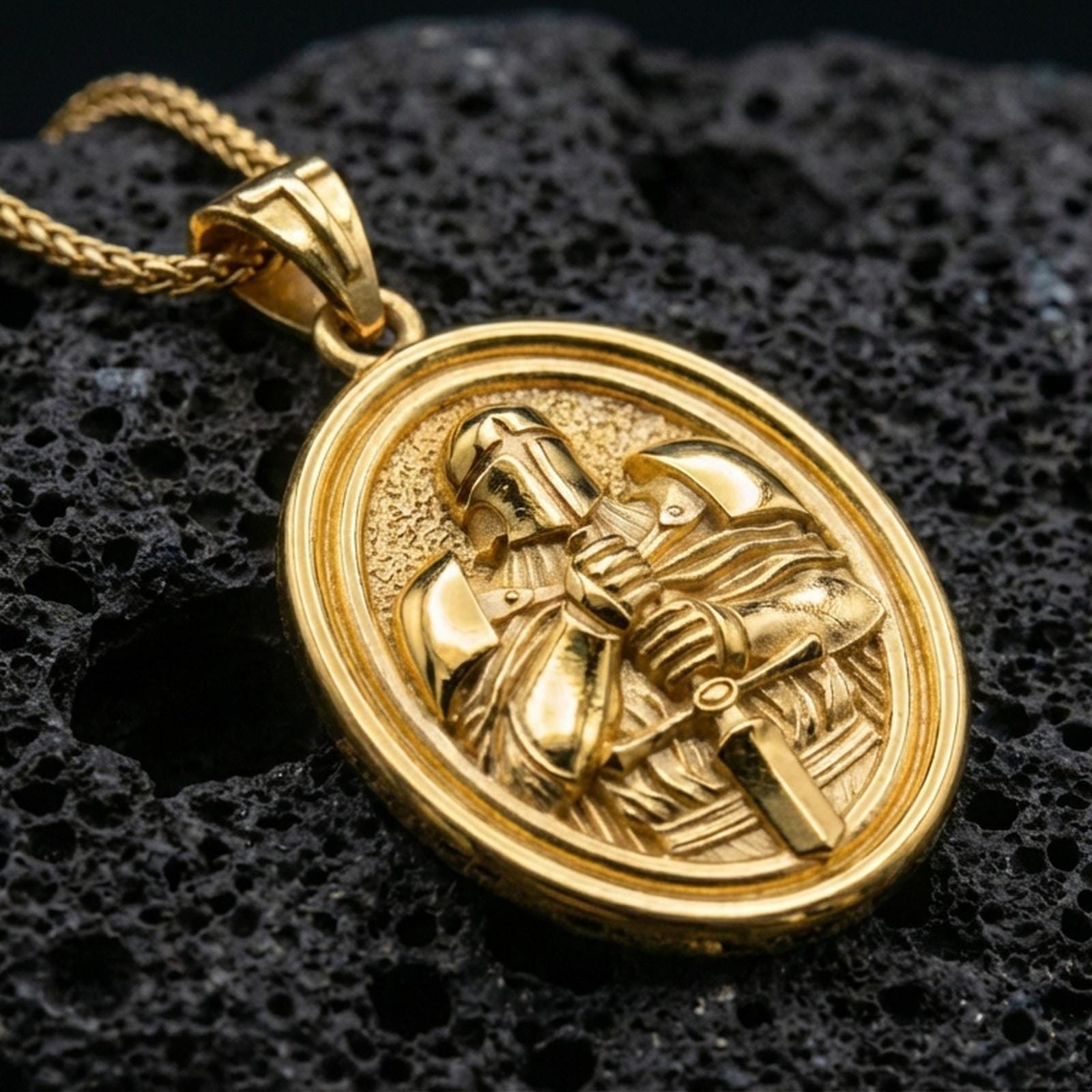 Gold plated Knight Templar pendant with helmeted warrior design, rotating oval medallion form, and engraved crusader symbolism showcased on black volcanic rock in a refined macro jewelry image