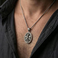 Load image into Gallery viewer, Oxidized Knight Templar pendant with armored crusader figure worn on the neck in a lifestyle jewelry shot, styled against the chest for a bold and medieval statement look
