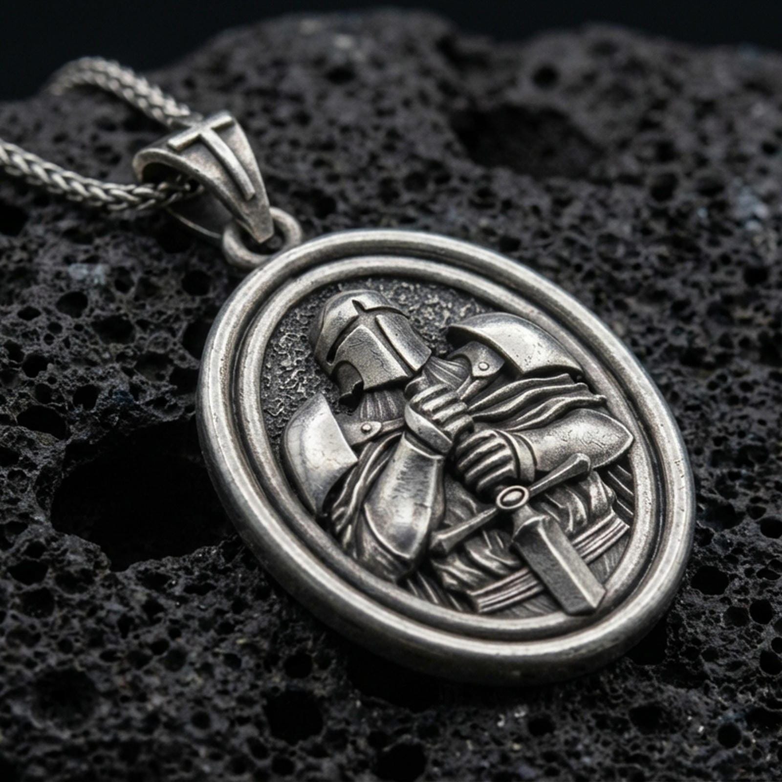 Oxidized Knight Templar pendant with crusader helmet, sword detail, and oval rotating medallion design displayed on dark volcanic rock in a close-up luxury jewelry composition