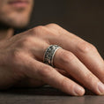Load image into Gallery viewer, Oxidized sterling silver koi fish band ring worn on the finger, lifestyle image focusing on bold dark depth, symbolic koi flow, and daily wear presence.

Polished silver koi fish band ring worn on the finger, lifestyle shot highlighting clean brightness, sharp relief definition, and versatile styling.
