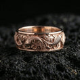 Load image into Gallery viewer, Rose gold plated koi fish band ring on volcanic stone, elegant macro close-up capturing soft rose reflections across the koi and wave detailing.

