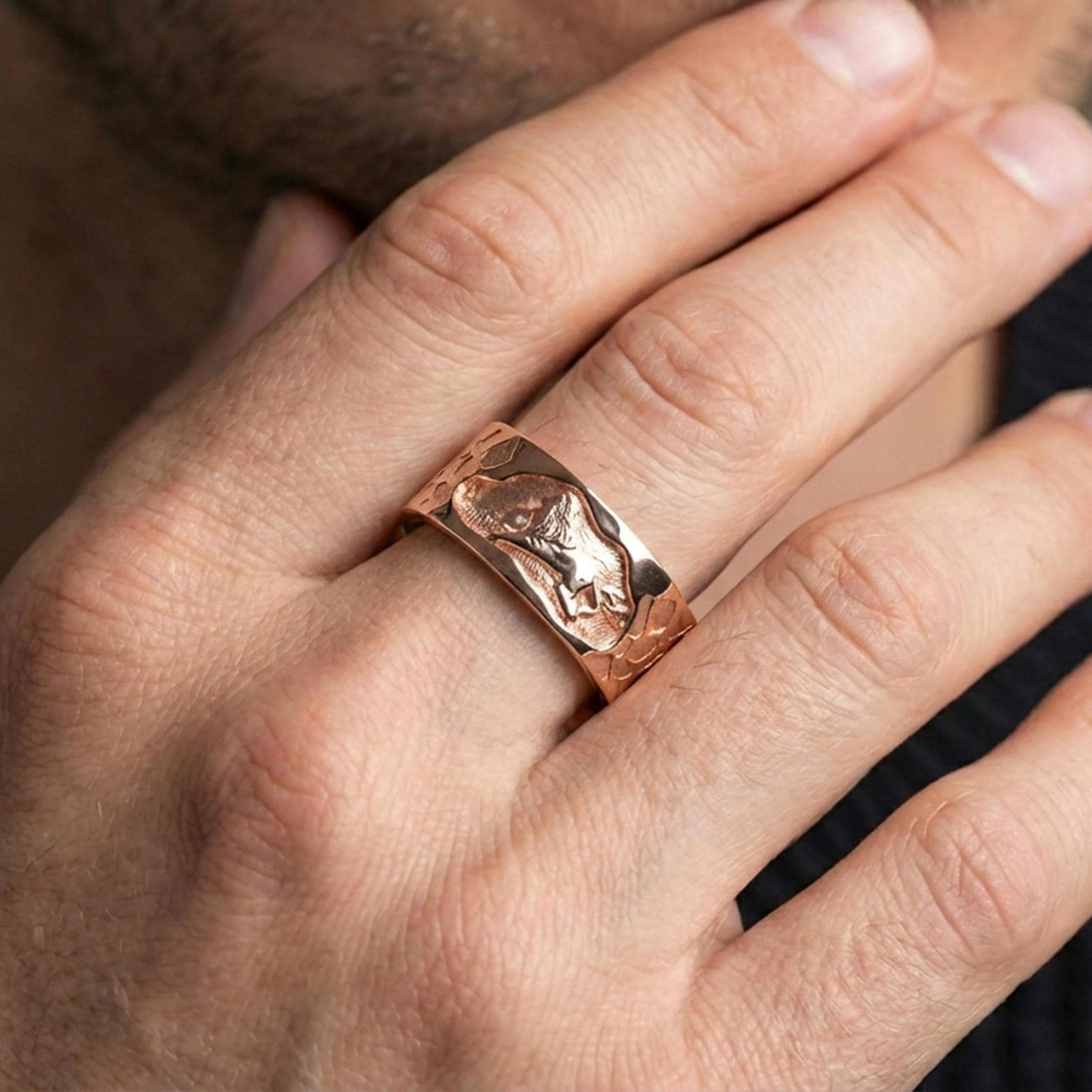 Rose gold plated lion band ring worn on the finger, lifestyle image showcasing elegant rose tone, detailed lion carving, and premium finishing.