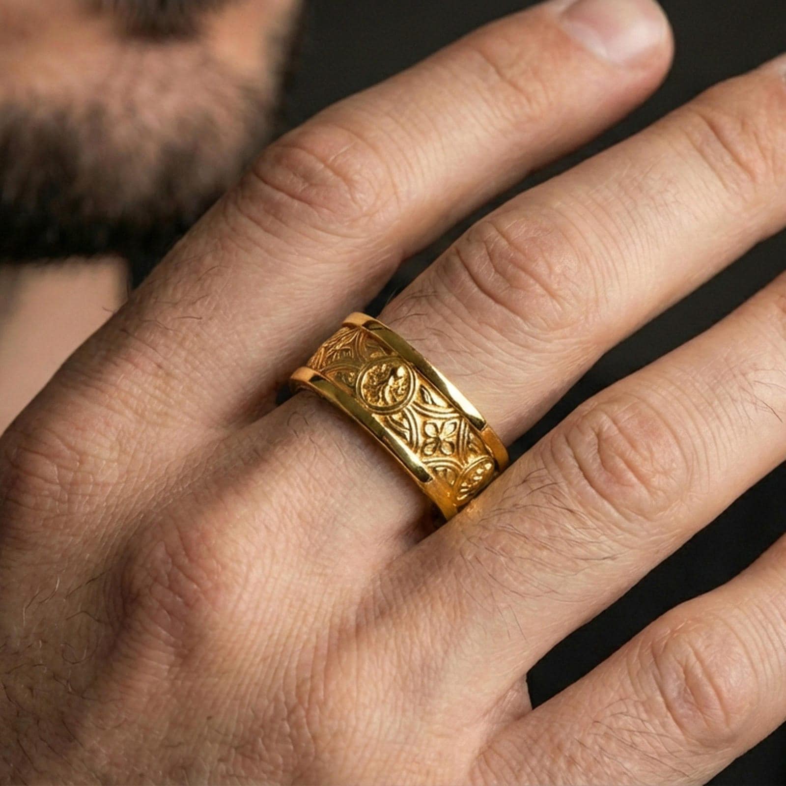 Gold plated spinner ring worn on the finger, lifestyle photo emphasizing luxury warmth, eye-catching knotwork pattern, and gift-ready presence.
