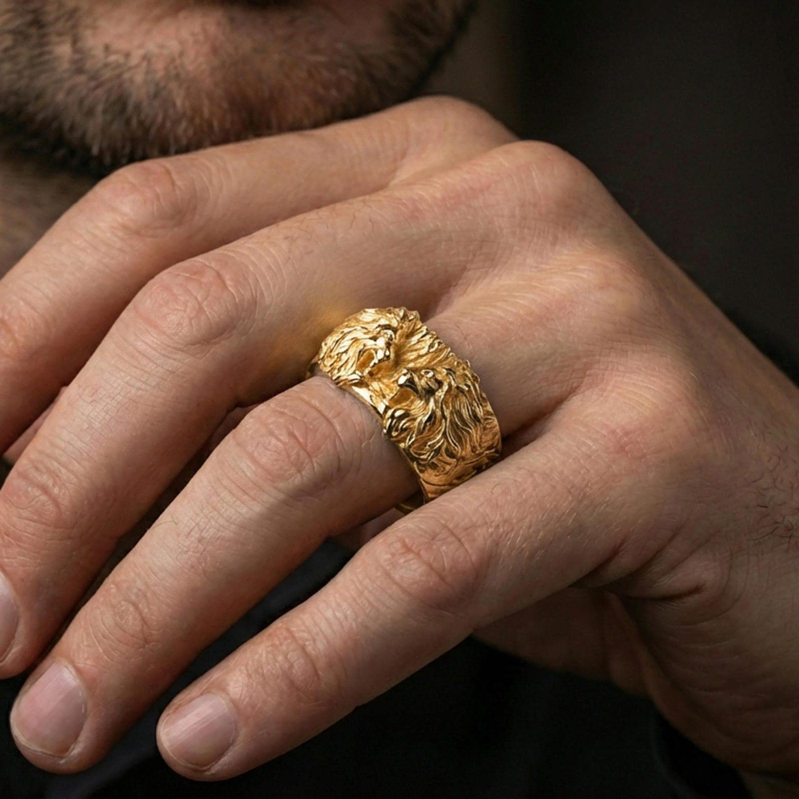 Gold plated lion head ring worn on the finger, lifestyle photo emphasizing luxury warmth, powerful lion motif, and gift-ready impact.
