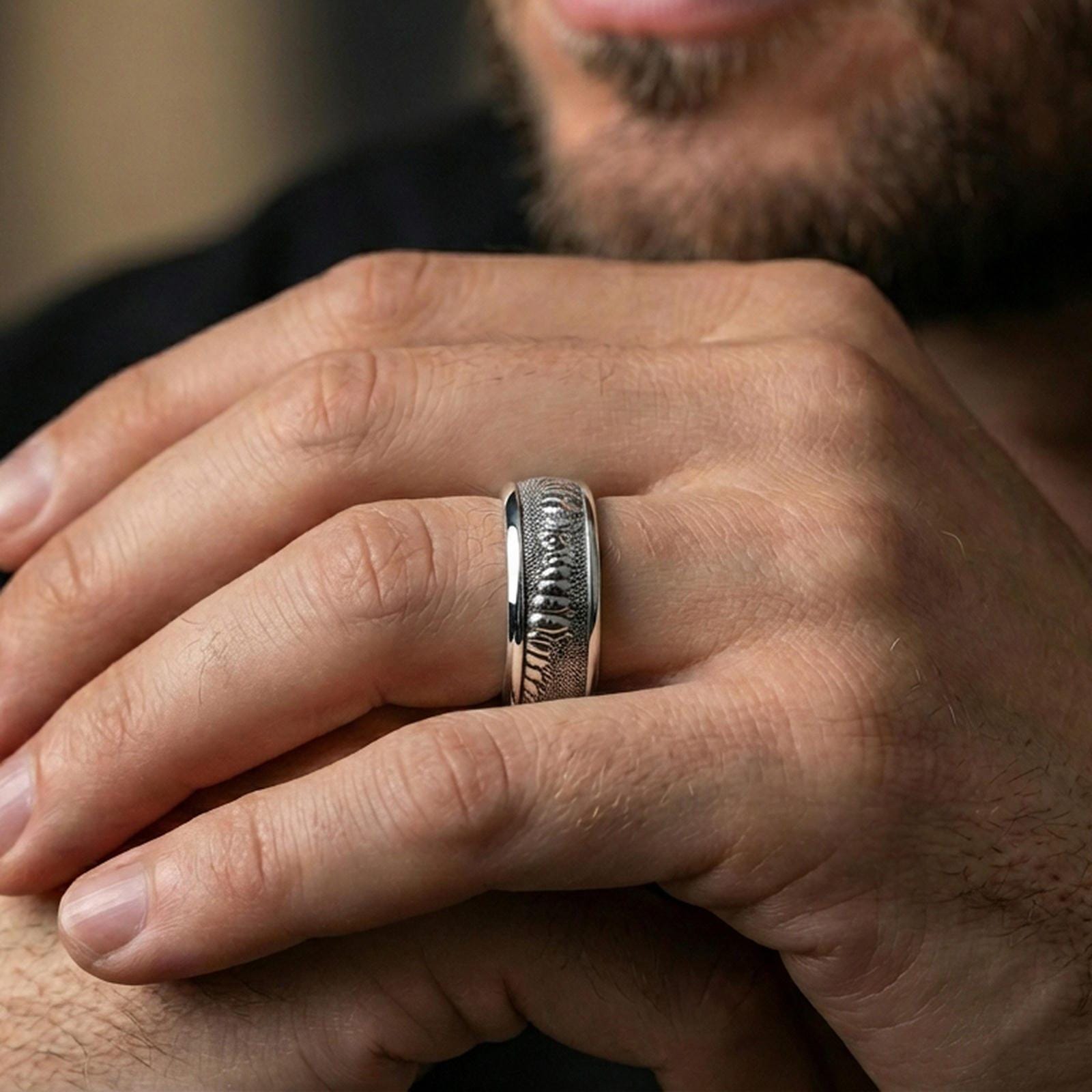 Polished silver lizard skin spinner ring worn on the finger, lifestyle shot highlighting modern shine, tactile reptile pattern, and everyday fidget-ready wear.