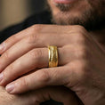 Load image into Gallery viewer, Gold plated lizard skin spinner ring worn on the finger, lifestyle photo emphasizing luxury warmth, statement texture, and smooth spinning function.
