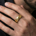 Load image into Gallery viewer, Gold plated Greek sculpture ring worn on the finger, lifestyle photo emphasizing rich gold presence, sculptural cameo detail, and elevated heritage look.
