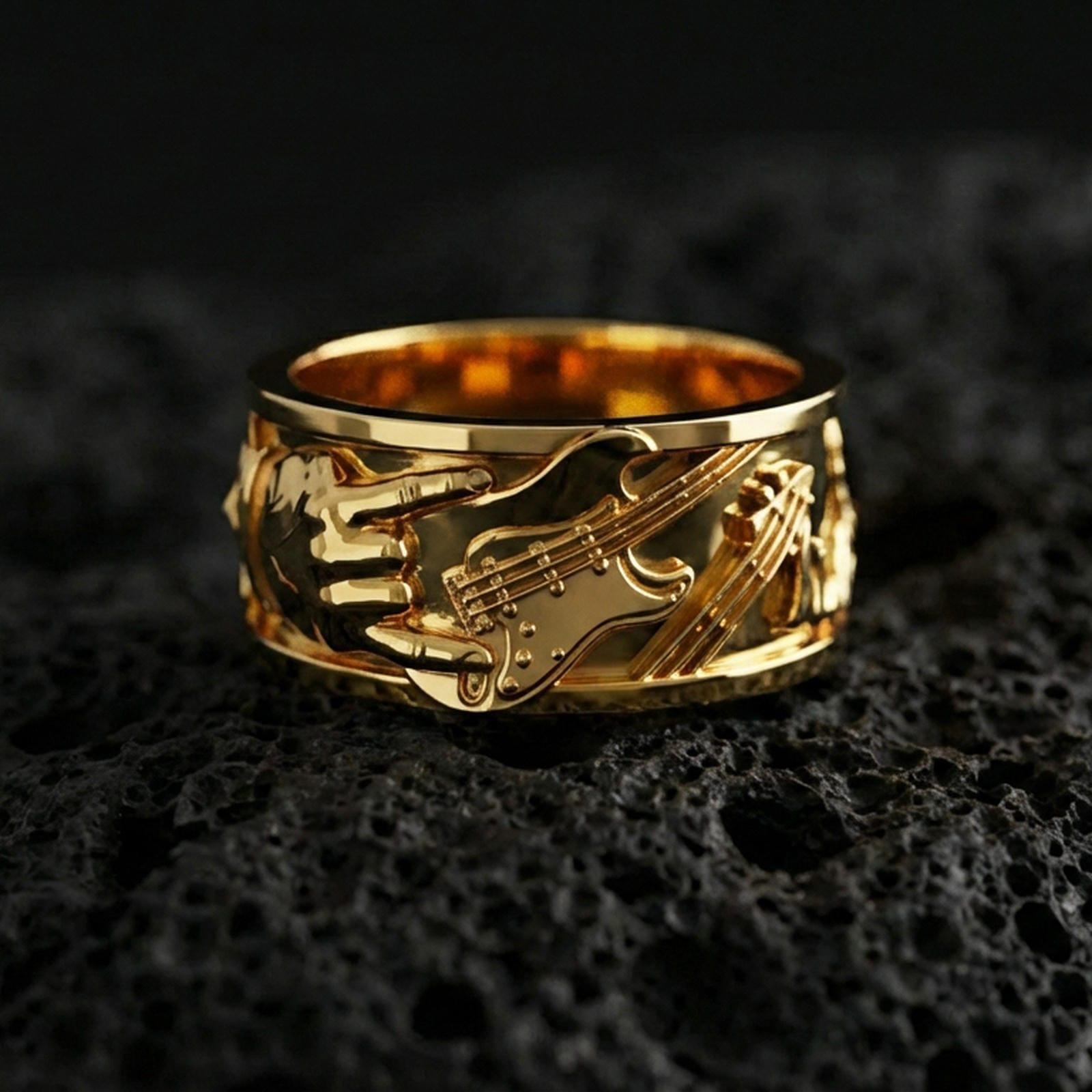 Gold plated guitar ring on volcanic stone, luxury macro photo capturing warm golden tone across the guitar body, strings, and textured relief.
