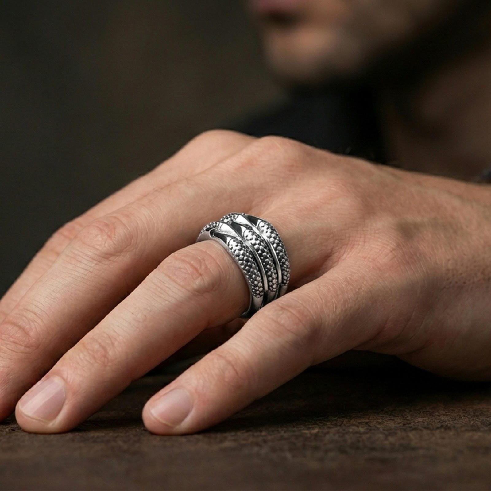 Polished silver layered studded band ring worn on the finger, lifestyle shot highlighting modern clean styling, structured edges, and comfortable daily wear.