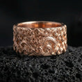 Load image into Gallery viewer, Rose gold plated dragon cloud band ring on volcanic stone, refined macro close-up showcasing soft rose warmth, sculpted cloud curls, and dragon detail.
