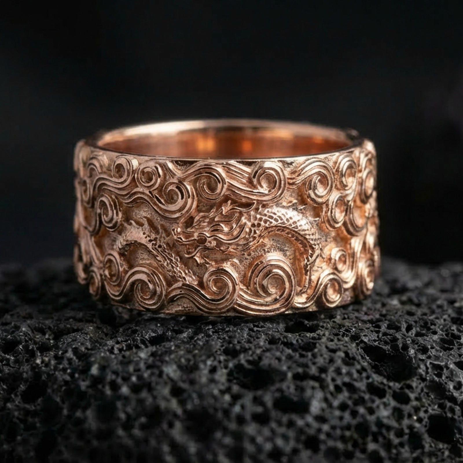 Rose gold plated dragon cloud band ring on volcanic stone, refined macro close-up showcasing soft rose warmth, sculpted cloud curls, and dragon detail.