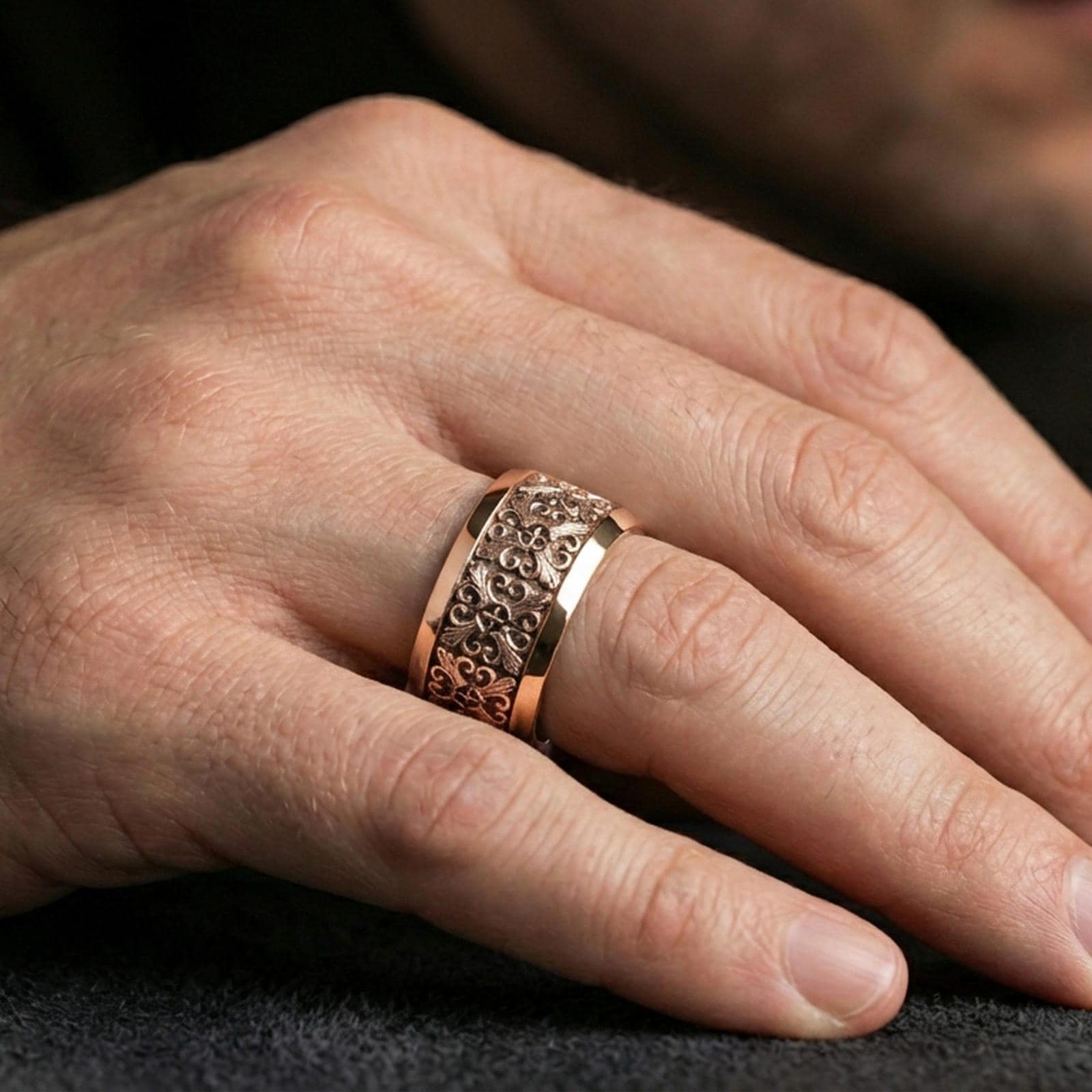 Rose gold plated cross scrollwork band ring worn on the finger, lifestyle image highlighting elegant rose tone, refined filigree texture, and modern unisex styling.