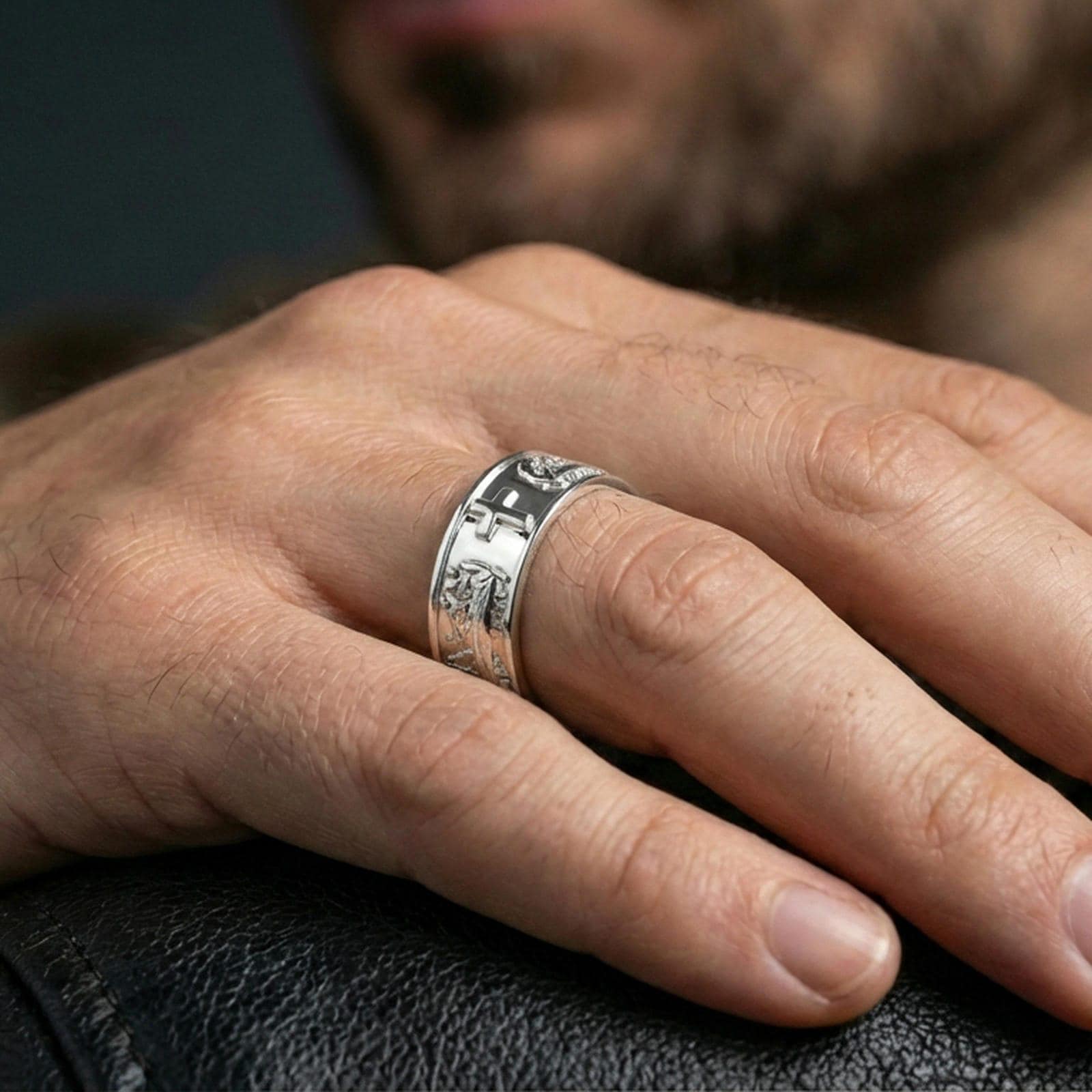 Polished silver cross band ring worn on the finger, lifestyle photo presenting a sleek shine, clean lines, and a modern faith-inspired profile.
