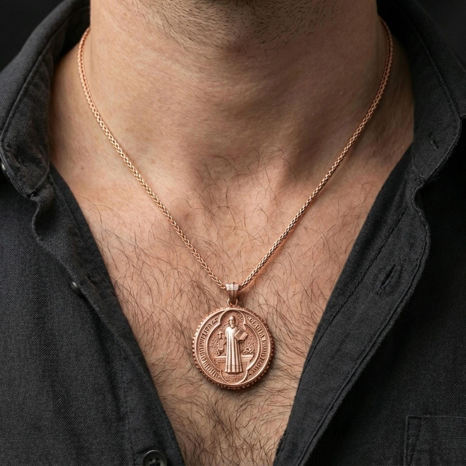 Rose gold plated Saint Benedict necklace with detailed medallion design and religious inscriptions worn on the neck in a refined lifestyle shot with a warm and elegant presentation