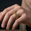 Load image into Gallery viewer, Gothic cross spinner ring worn on a finger, gold plated look creating a strong statement while keeping the cross relief sharp and visible.
