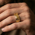 Load image into Gallery viewer, Rotating wave spinner ring worn on a finger, gold plated look creating a bold nautical statement while keeping the wave relief sharp.
