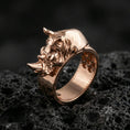 Load image into Gallery viewer, Sterling silver rhino head ring photographed on black volcanic stone, shown in a rose gold plated finish with warm reflections that enhance the sculpted rhino details.
