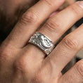 Load image into Gallery viewer, Koi fish spinner band ring worn on a finger, polished silver finish with crisp reflective edges and clear relief depth.
