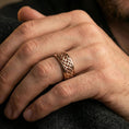 Load image into Gallery viewer, Celtic knot spinner band ring worn on a finger, rose gold plated finish with a smooth comfort-fit profile and elegant warm reflections.
