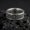 Load image into Gallery viewer, Gothic fleur-de-lis band ring on black volcanic stone, shown in an oxidized sterling silver finish with deep darkened recesses emphasizing the medieval lattice details.
