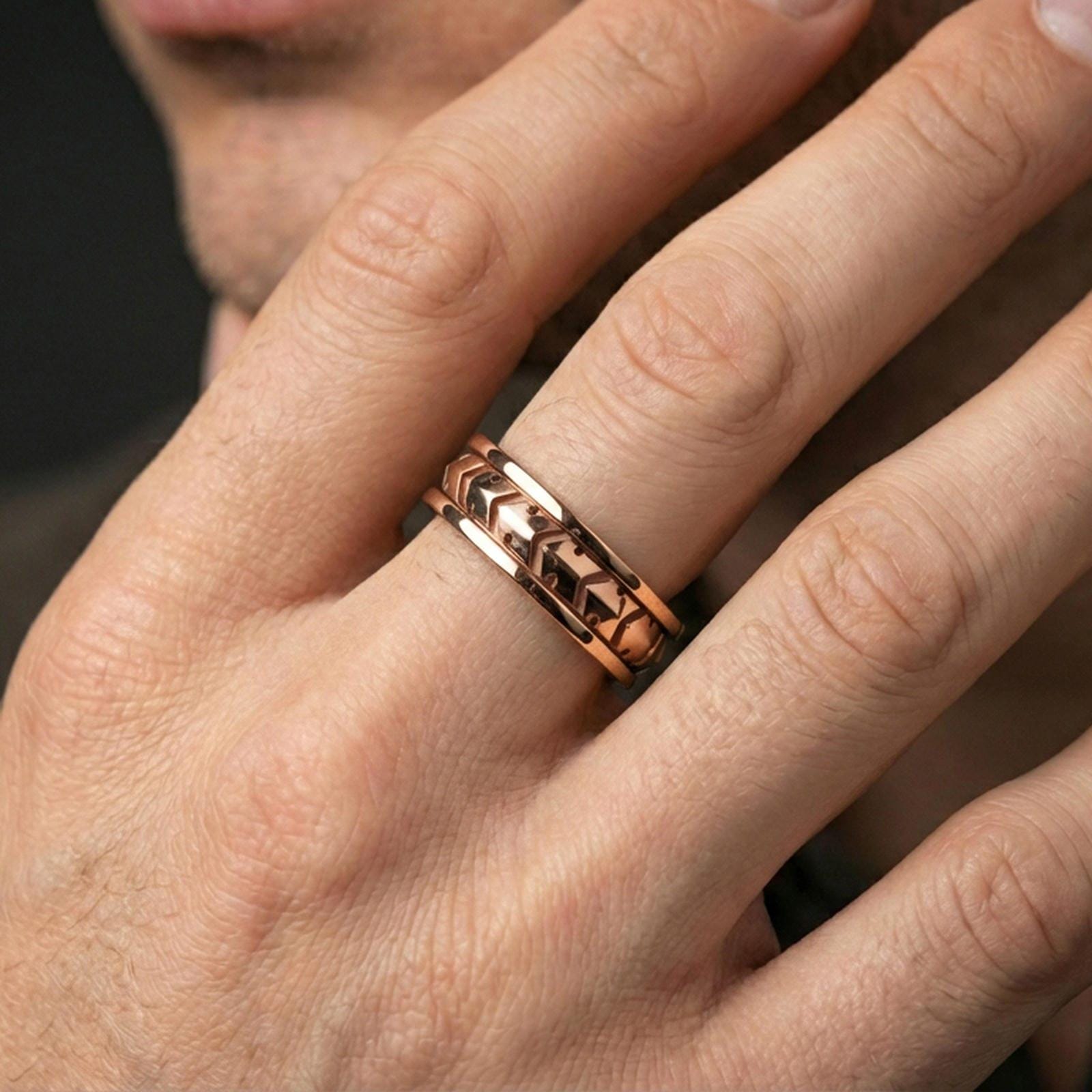 Industrial tread pattern sterling silver spinner ring worn on a finger, rose gold plated finish with elegant warmth while maintaining the industrial details.