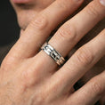 Load image into Gallery viewer, Industrial tread pattern sterling silver spinner ring worn on a finger, polished silver finish with a sleek shine and defined tread edges.
