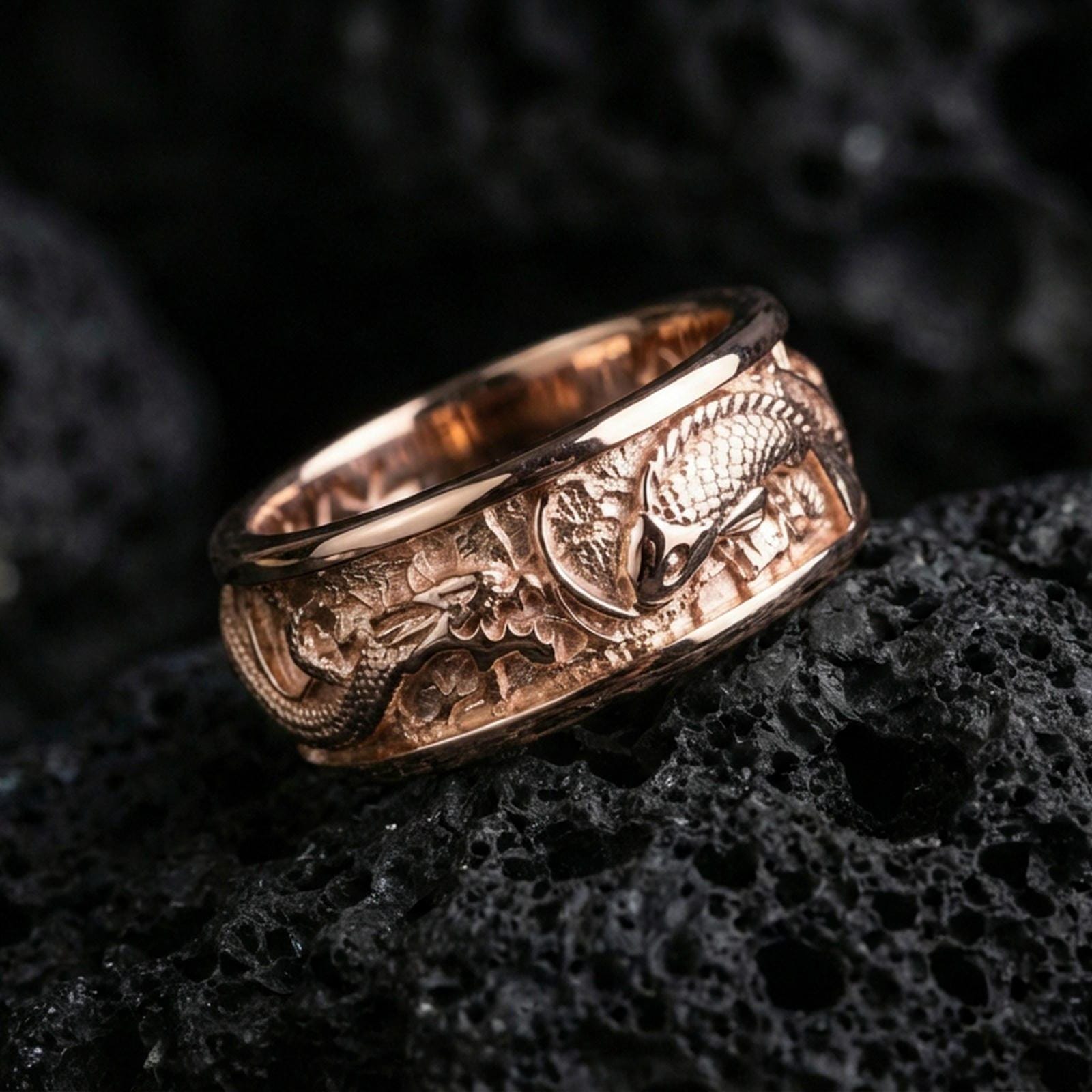 Rose gold plated sterling silver dragon and koi fish ring on volcanic stone, detailed relief scene with strong contrast, minimal high-end close-up.