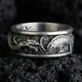 Load image into Gallery viewer, Oxidized sterling silver dragon and koi fish band ring on dark volcanic rock, Japanese-inspired relief details, premium macro product shot.
